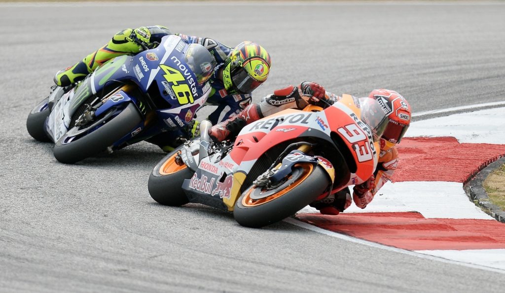 Yamaha rider Valentino Rossi follows Marc Marquez of Honda during the 2015 MotoGP Malaysian Grand Prix