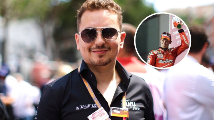 Jorge Lorenzo in the F1 paddock with Casey Stoner atop a podium in the overlay image