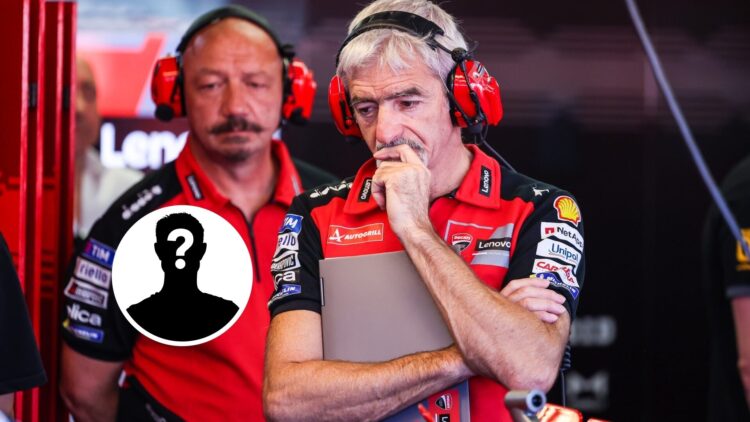 Luigi Dall'Igna of Ducati ponders inside the San Marino Grand Prix garage with a mystery image overlay to the left of him