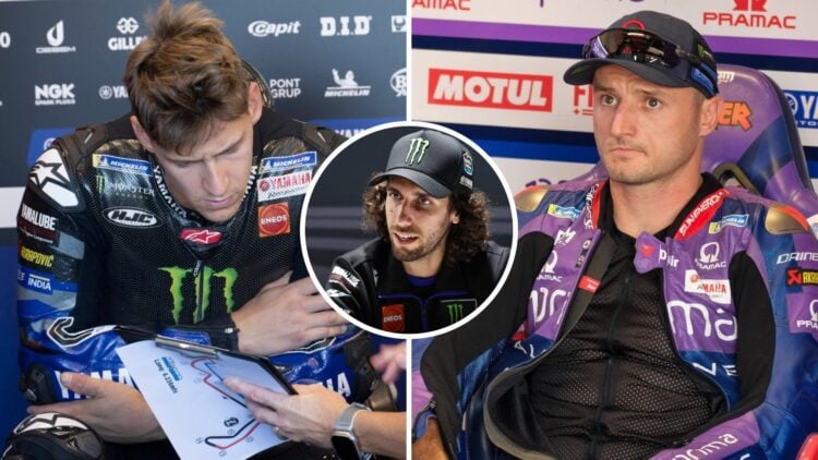 Yamaha rider Fabio Quartararo studies his data during the 2025 MotoGP Misano test and Pramac's Jack Miller looks on from the garage during practice...