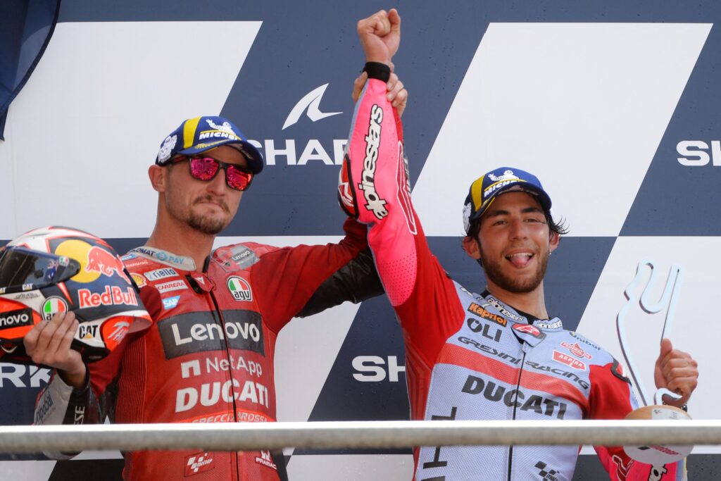 Jack Miller lifts Enea Bastianini's hand in the air after winning the 2022 MotoGP French Grand Prix at Le Mans