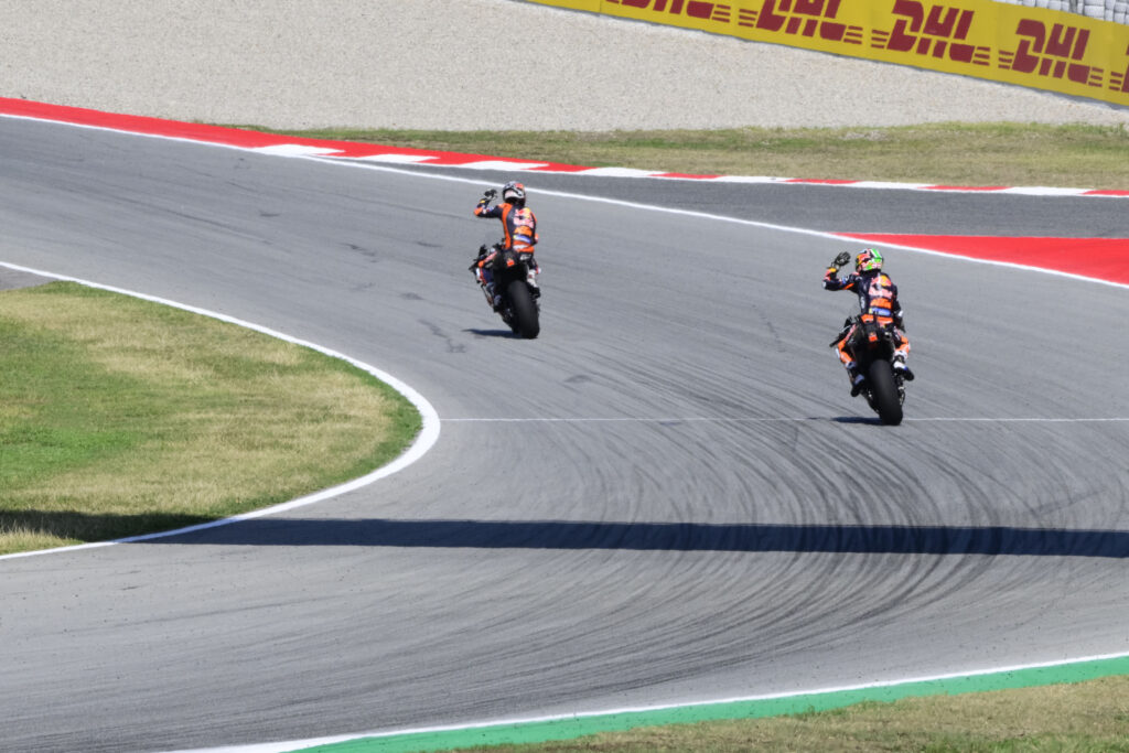 KTM riders Brad Binder and Pedro Acosta wave to fans during practice for the 2025 MotoGP Catalan Grand Prix in Barcelona