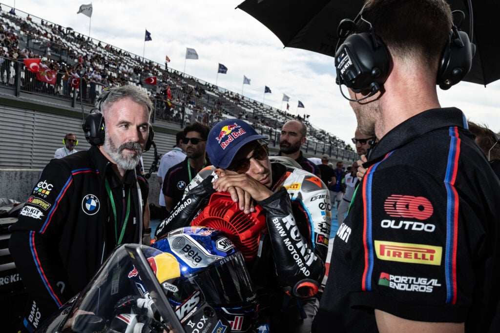 BMW World Superbikes rider Toprak Razgatlioglu speaks with his crew chief, Phil Marron, on the Magny-Cours grid