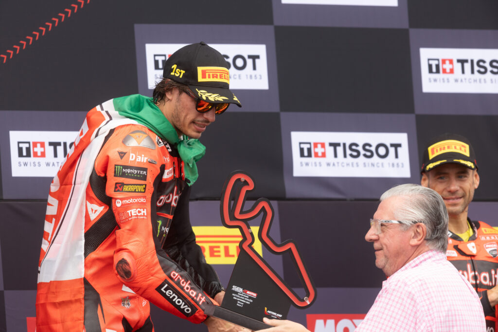 Nicolo Bulega receiving his winners trophy on the podium during the Aragon round of the World SuperBikes Championship.