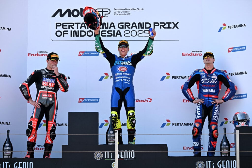 Italtrans rider Diogo Moreira celebrates winning the 2025 Moto2 Indonesian Grand Prix at Mandalika with P2 finisher Manuel Gonzalez on the podium before the Intact GP rider's disqualification
