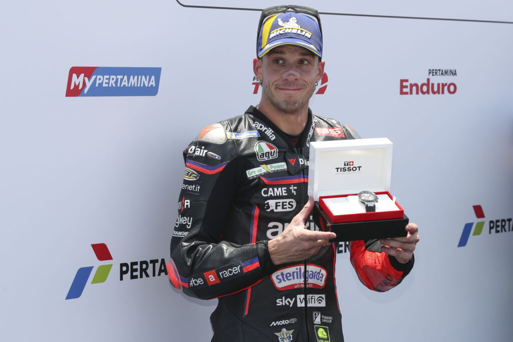 Aprilia rider Marco Bezzecchi celebrates scoring pole position for the 2025 MotoGP Indonesian Grand Prix after qualifying at Mandalika