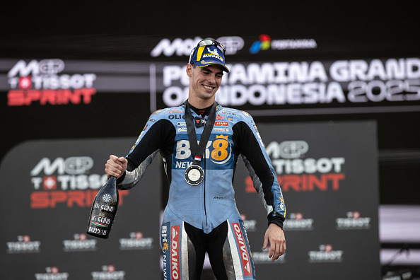 Fermin Aldeguer of Gresini holds a bottle of prosecco on the Indonesian Grand Prix Sprint podium