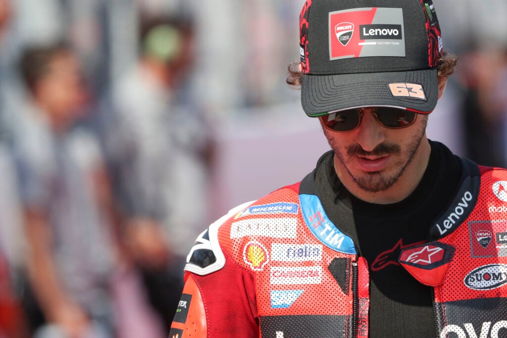 Ducati rider Francesco Bagnaia walks to the grid at the 2025 Indonesian Grand Prix