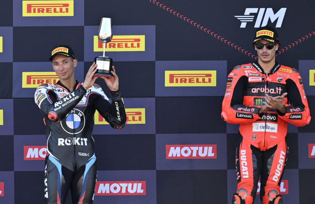BMW rider Toprak Razgatlioglu celebrates with his P2 trophy after Race 1 at the 2025 World Superbike Championship round at Jerez as Ducati's Nicolo Bulega looks on