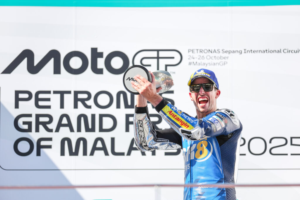 Gresini's Alex Marquez celebrates with his trophy on the Sepang podium after winning the 2025 MotoGP Malaysian Grand Prix