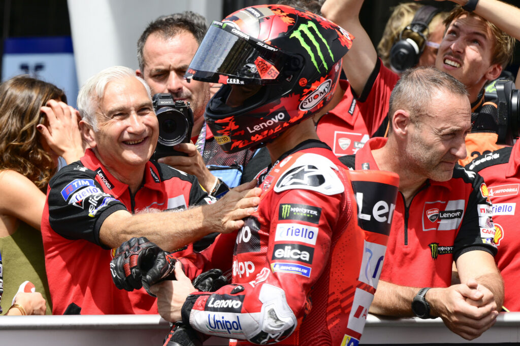 Ducati rider Francesco Bagnaia celebrates scoring pole position for the 2025 MotoGP Malaysian Grand Prix after qualifying with Davide Tardozzi at Sepang