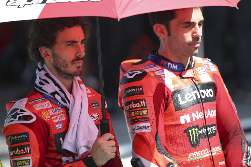Ducati rider Francesco Bagnaia and test rider Michele Pirro on the grid before the 2025 MotoGP Malaysian Grand Prix
