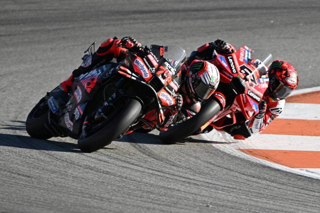 Aprilia rider Marco Bezzecchi on track with Ducati's Francesco Bagnaia during practice for the 2025 MotoGP Valencia Grand Prix