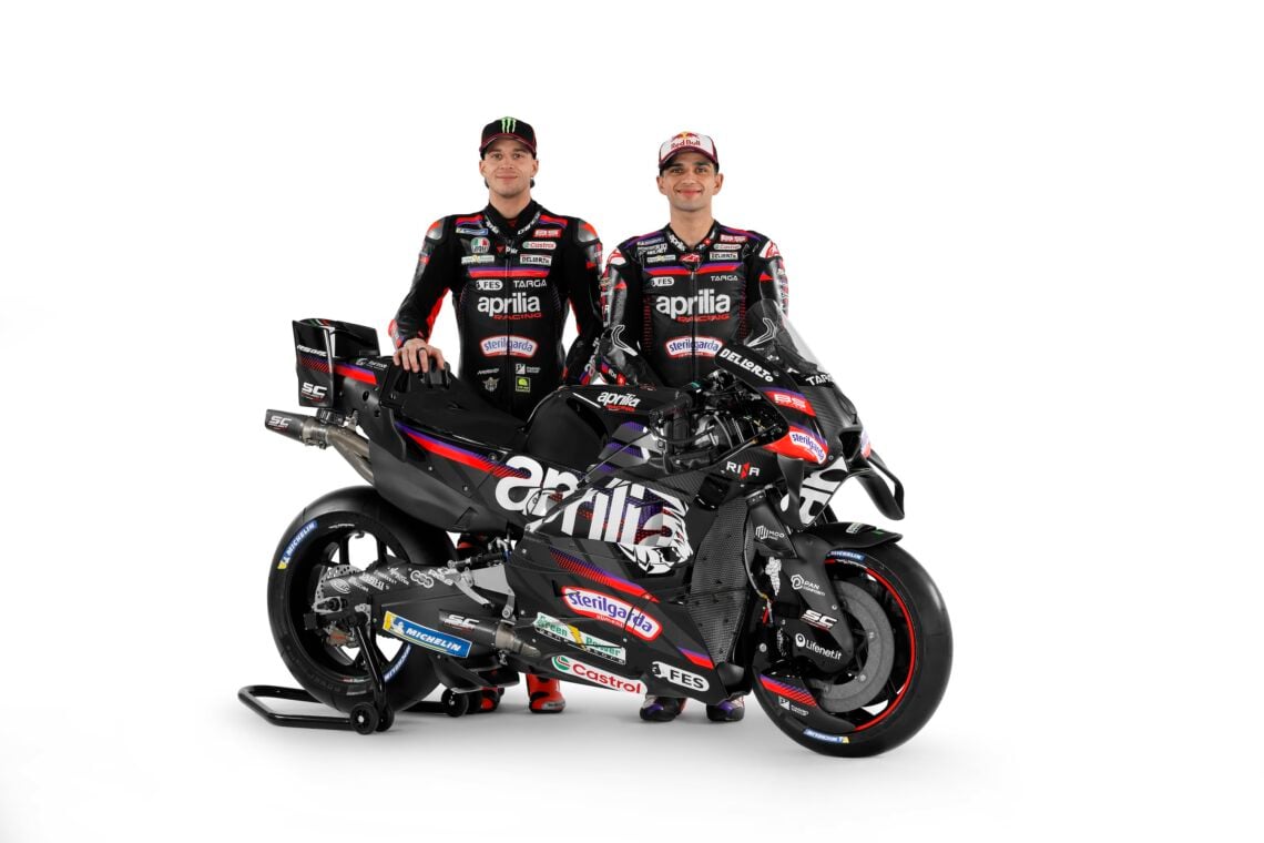 Marco Bezzecchi and Jorge Martin stand with the 2026 Aprilia Racing bike