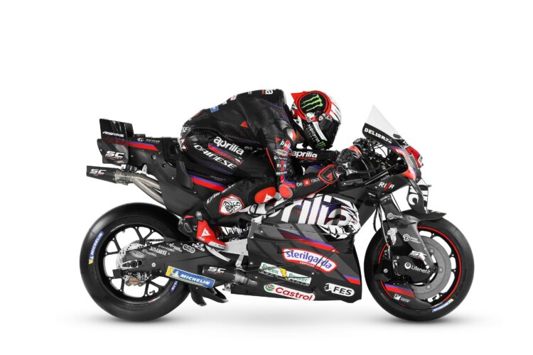 Marco Bezzecchi poses for a photo with the 2026 Aprilia bike
