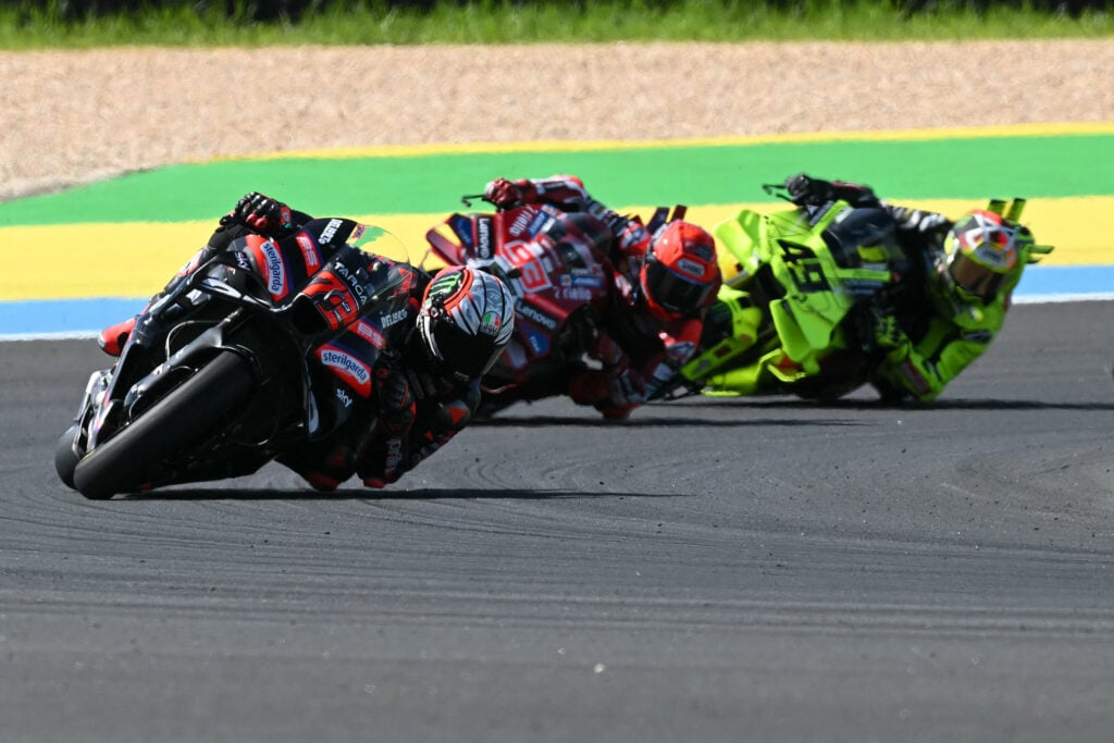 Aprilia rider Marco Bezzecchi leads Ducati's Marc Marquez and VR46's Fabio Di Giannantonio during the 2026 MotoGP Brazilian Grand Prix