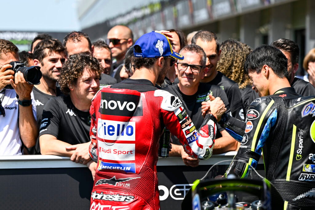 Ducati's Francesco Bagnaia congratulates Trackhouse rider Ai Ogura after scoring pole for the 2026 MotoGP Czech Grand Prix.