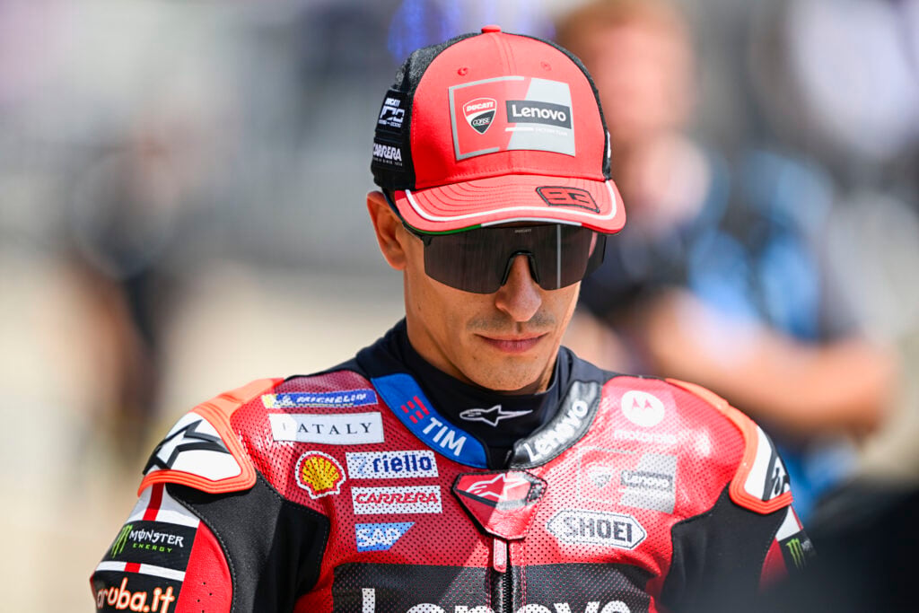Marc Marquez of Ducati walks in the MotoGP pit lane